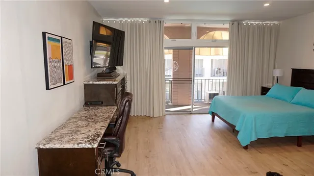 a living room with a bed furniture and a window