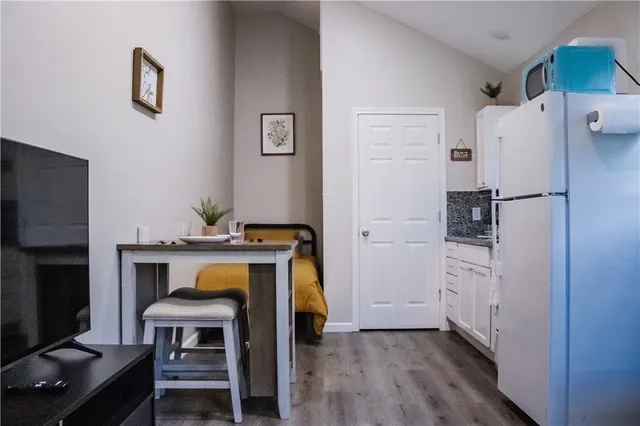 a view of kitchen with furniture and wooden floor