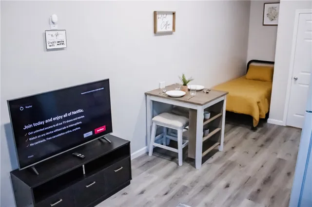 a view of a workspace with furniture and wooden floor