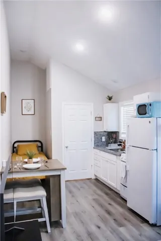 a kitchen with a stove a refrigerator and a stove top oven