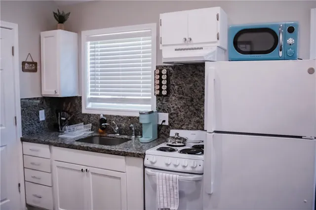 a kitchen with stainless steel appliances granite countertop a stove and a sink