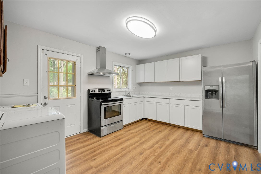 5322 Germain Road Richmond, VA 23224 - Photo 9 of 22 Kitchen featuring wood-finish flooring, white cabi