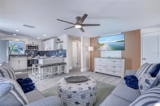 a living room with furniture and kitchen view