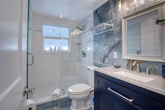 a bathroom with a sink toilet and shower