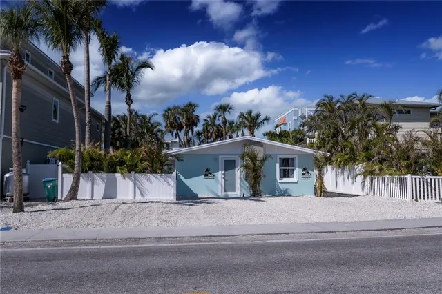 a view of backyard with palm trees