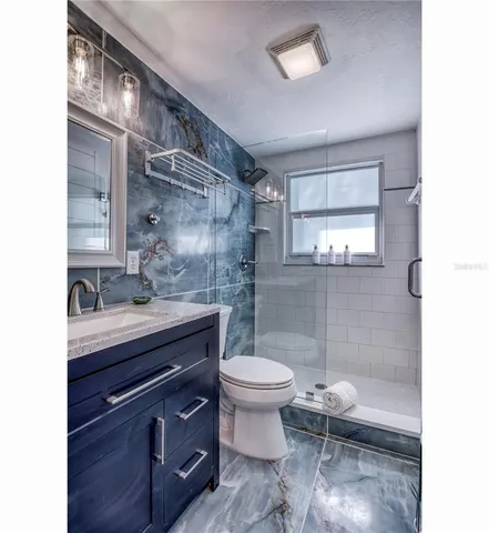 a kitchen with stainless steel appliances granite countertop a sink a stove and cabinets