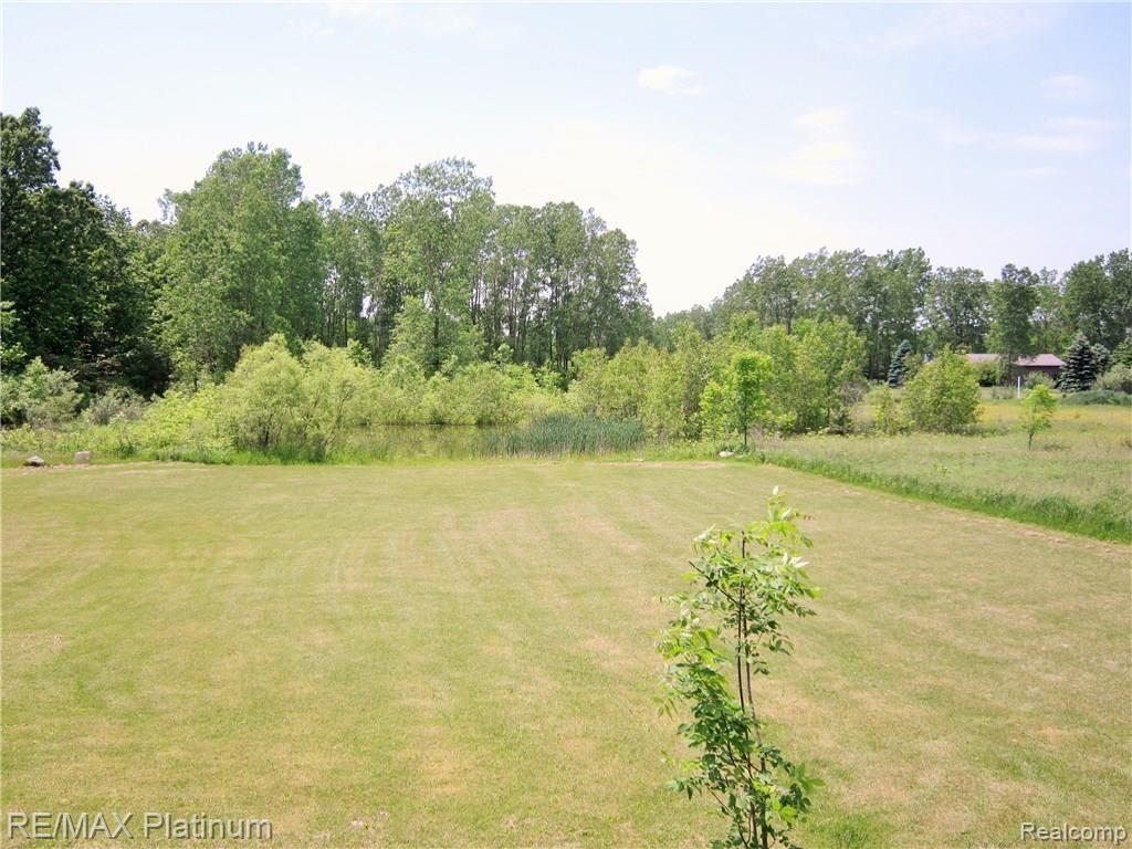 7011 Oak Grove Road Howell, MI 48855 - Photo 28 of 30 View of deck of pond and yard
