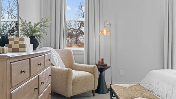 a bedroom with a bed and a table in it