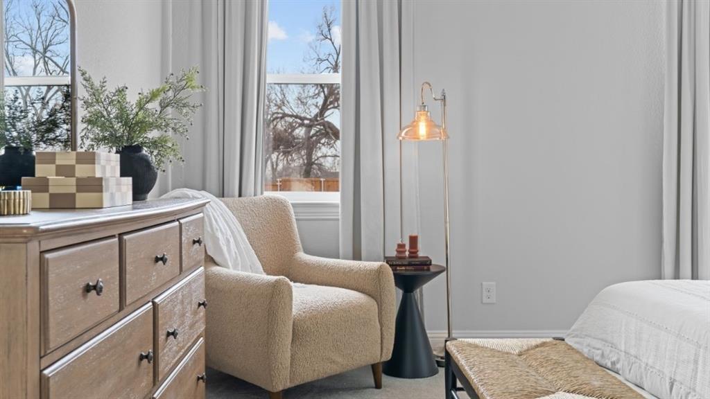 1633 Keneipp Road Carrollton, TX 75006 - Photo 12 of 18 a bedroom with a bed and a table in it