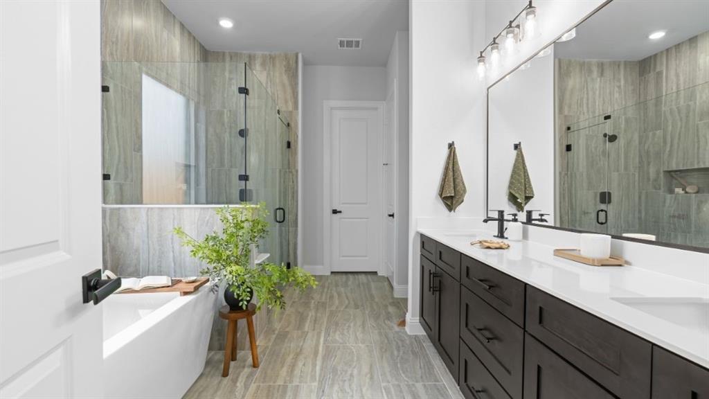 1633 Keneipp Road Carrollton, TX 75006 - Photo 13 of 18 a bathroom with a tub sink vanity granite and shower