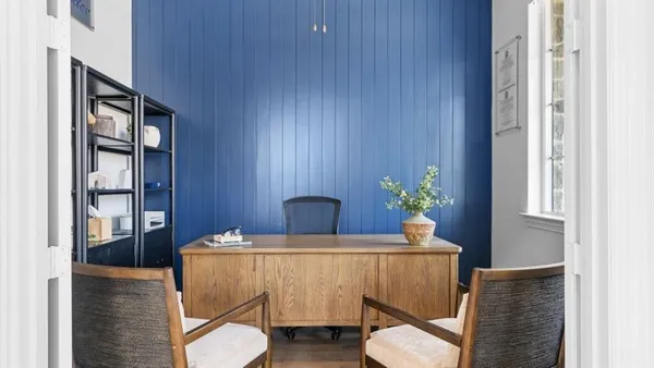 a dining room with furniture and wooden floor