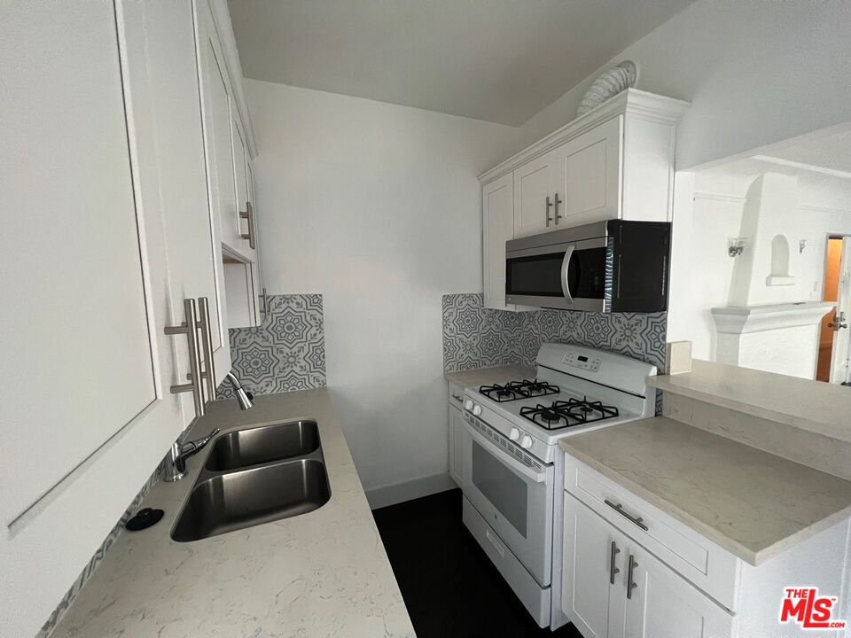 1217 Cedar Avenue Long Beach, CA 90813 - Photo 7 of 15 a kitchen with stainless steel appliances a stove microwave and sink