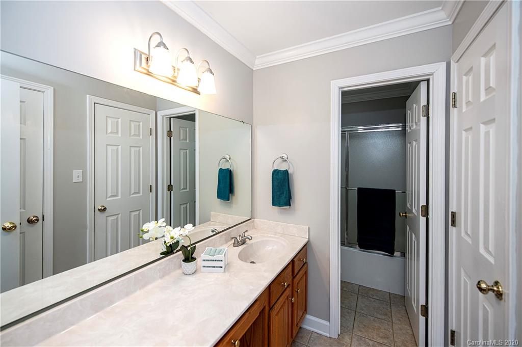 11135 Scullers Run Tega Cay, SC 29708 - Photo 17 of 33 a bathroom with a double vanity sink and mirror