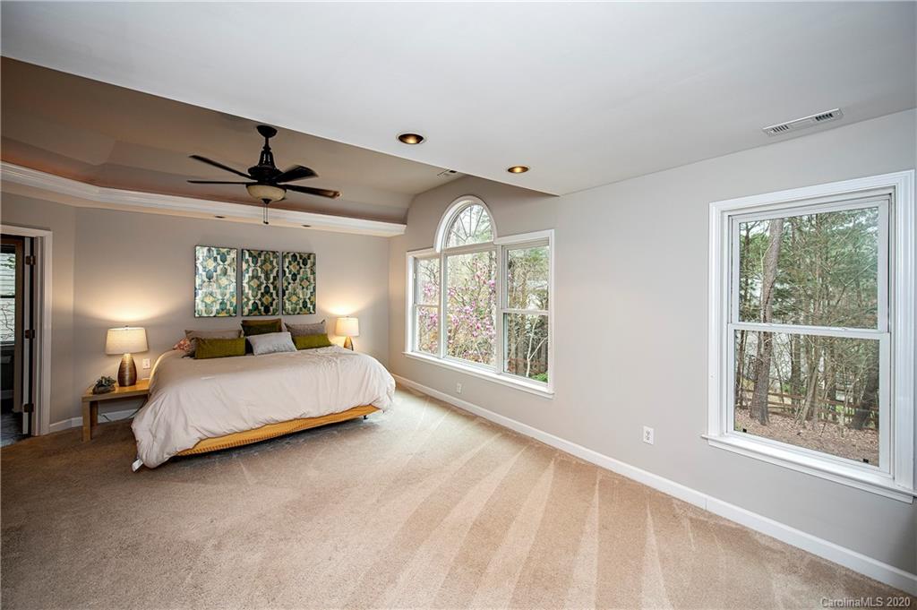 11135 Scullers Run Tega Cay, SC 29708 - Photo 21 of 33 a spacious bedroom with a bed and a large window