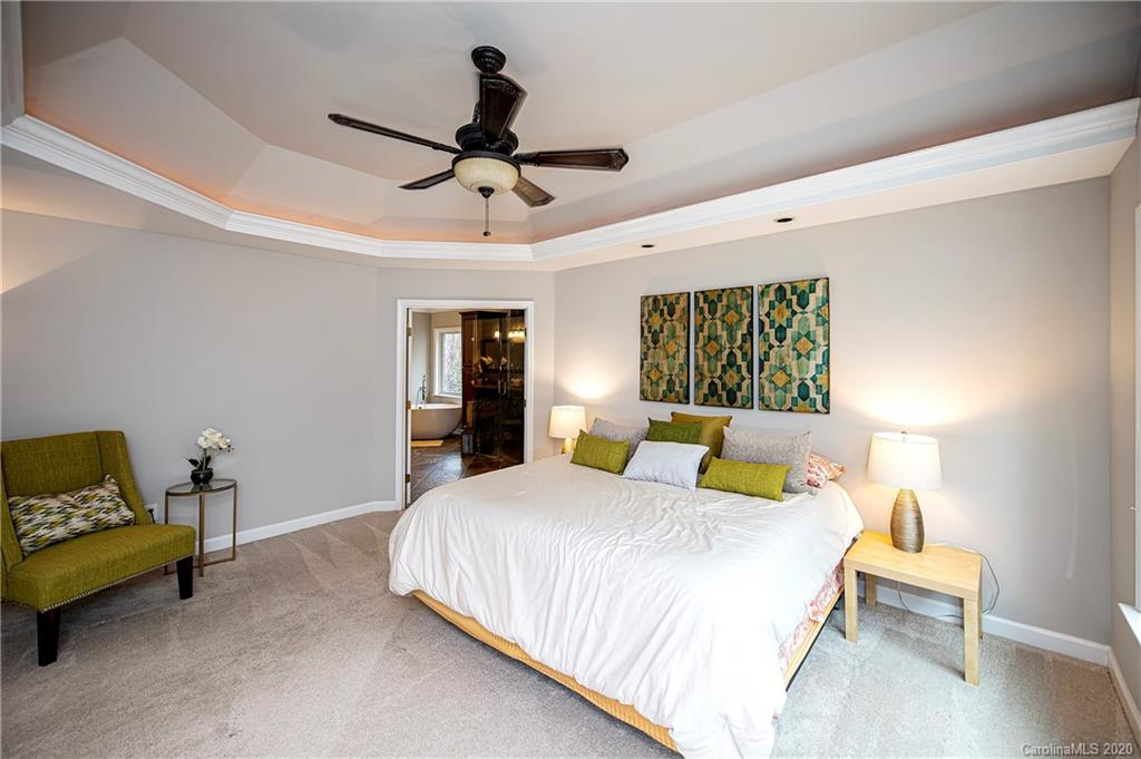 11135 Scullers Run Tega Cay, SC 29708 - Photo 22 of 33 a bedroom with a bed and wooden floor