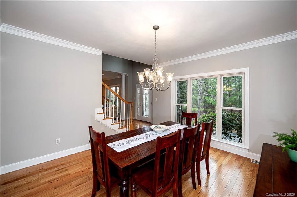 11135 Scullers Run Tega Cay, SC 29708 - Photo 7 of 33 a view of a dining room with furniture window and wooden floor