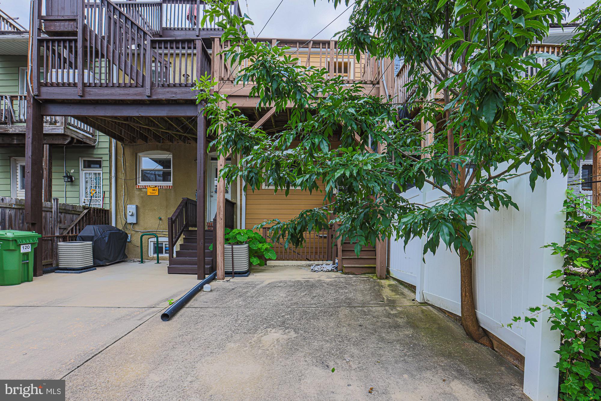 122 South Potomac Street Baltimore, MD 21224 - Photo 13 of 31 a view of a house with potted plants and large trees