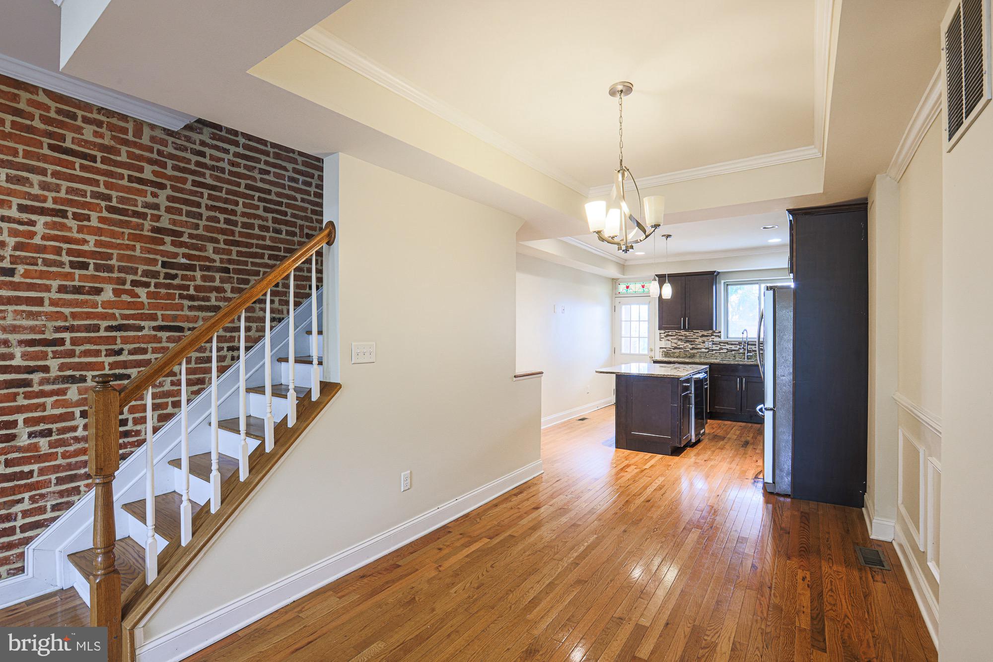 122 South Potomac Street Baltimore, MD 21224 - Photo 14 of 31 a view of a room with wooden floor windows and a chandelier