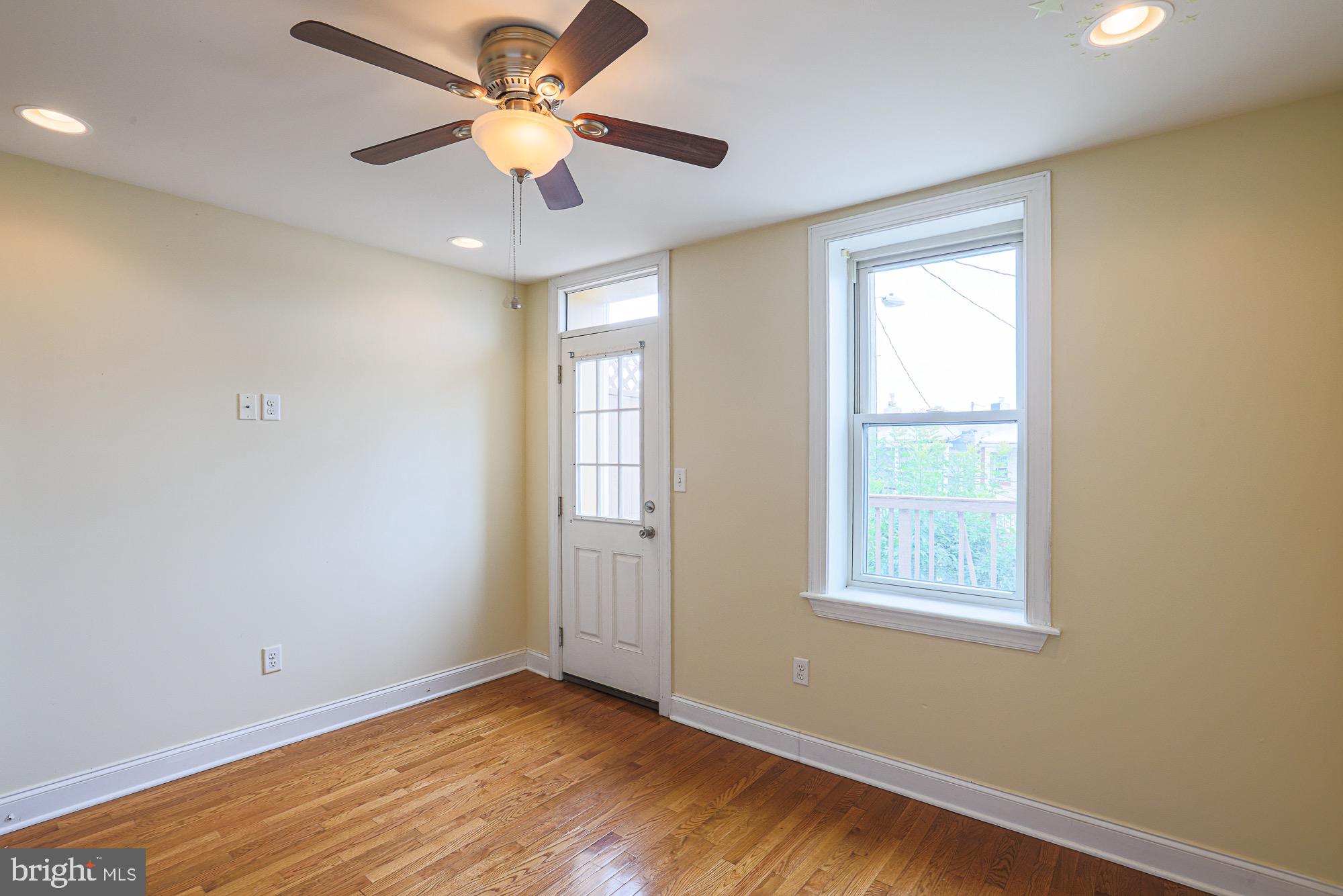 122 South Potomac Street Baltimore, MD 21224 - Photo 15 of 31 a view of an empty room with window and chandelier fan