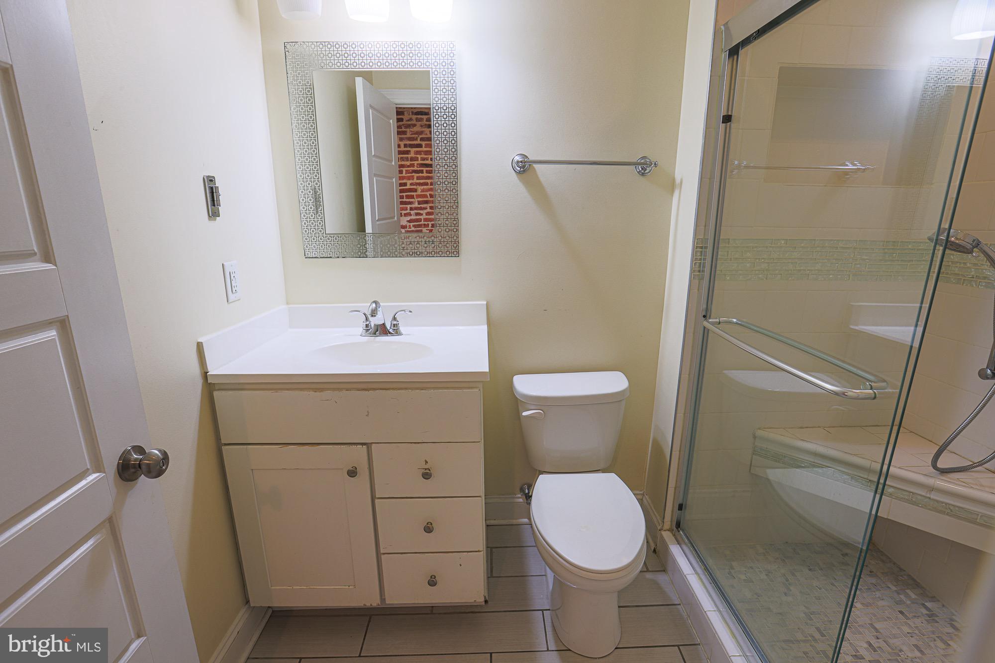122 South Potomac Street Baltimore, MD 21224 - Photo 19 of 31 a bathroom with a sink toilet and shower