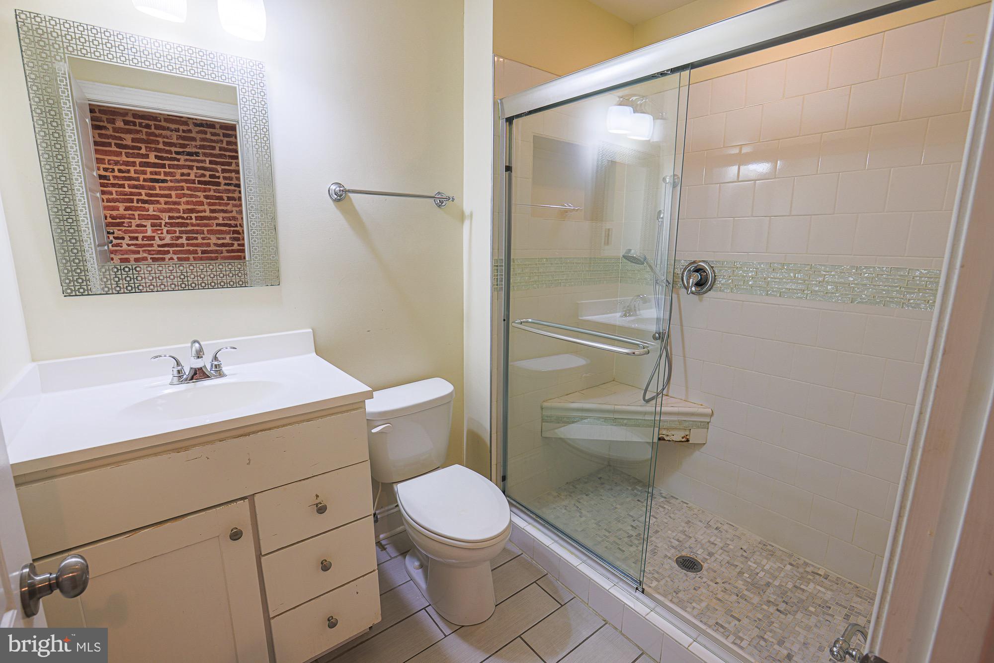 122 South Potomac Street Baltimore, MD 21224 - Photo 20 of 31 a bathroom with a sink a toilet and shower