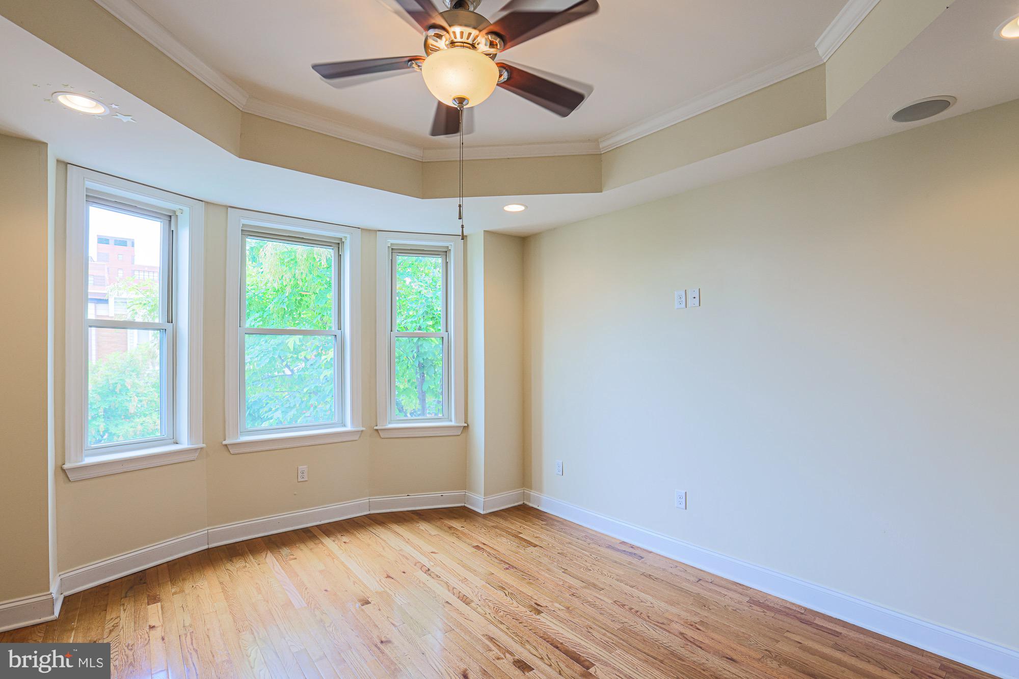 122 South Potomac Street Baltimore, MD 21224 - Photo 21 of 31 an empty room with wooden floor chandelier fan and windows