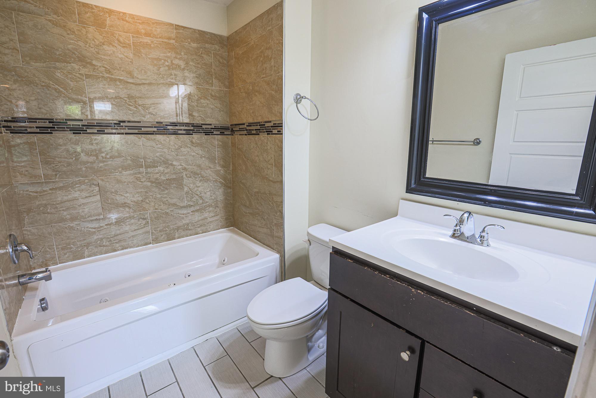 122 South Potomac Street Baltimore, MD 21224 - Photo 24 of 31 a bathroom with a sink a toilet and shower