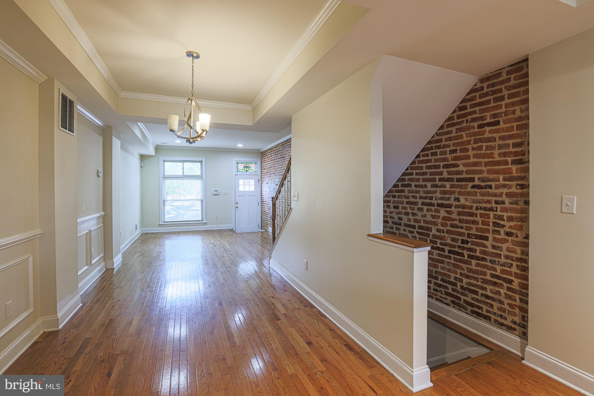 122 South Potomac Street Baltimore, MD 21224 - Photo 25 of 31 a view of a hallway with wooden floor and staircase