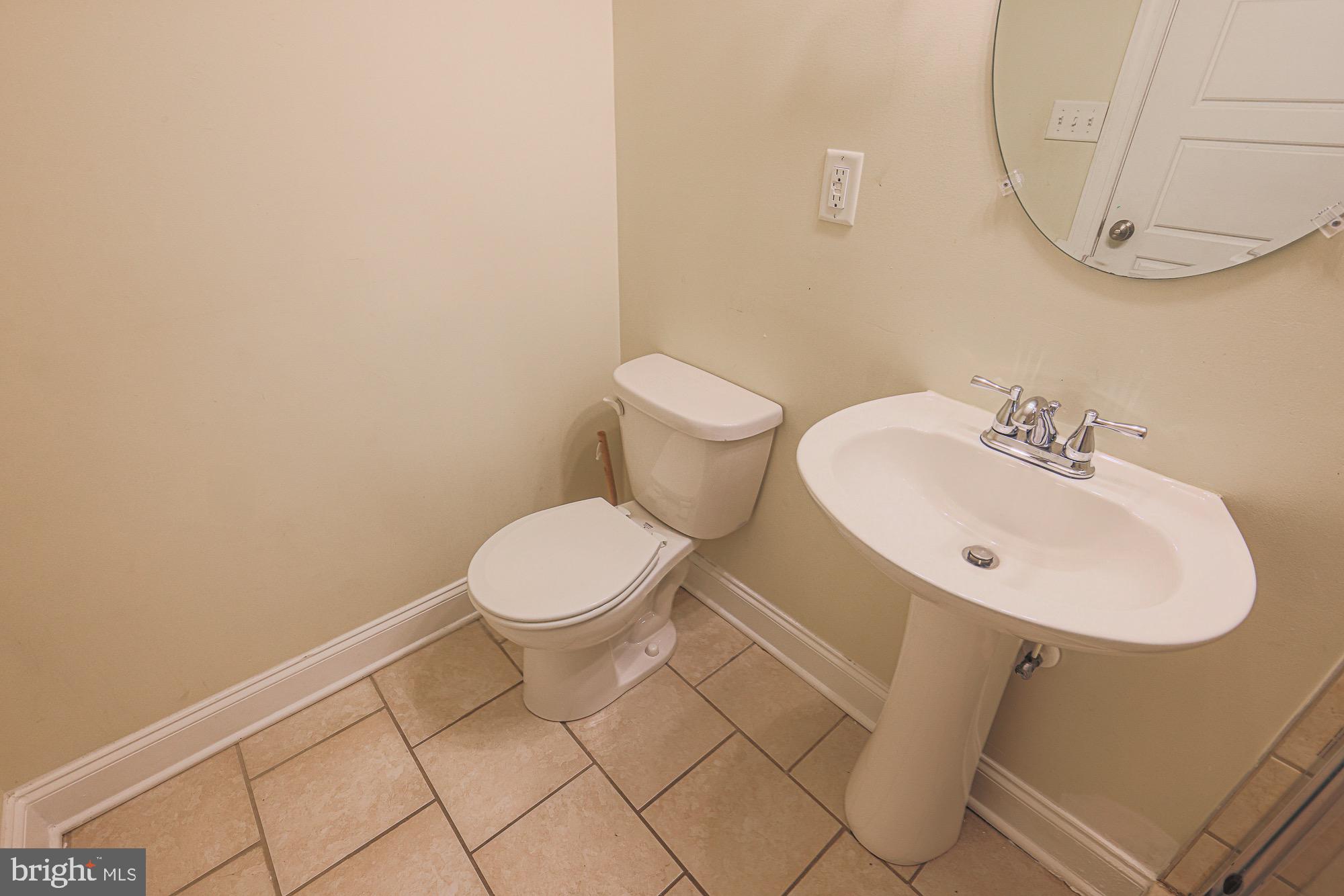 122 South Potomac Street Baltimore, MD 21224 - Photo 29 of 31 a bathroom with a sink mirror and toilet
