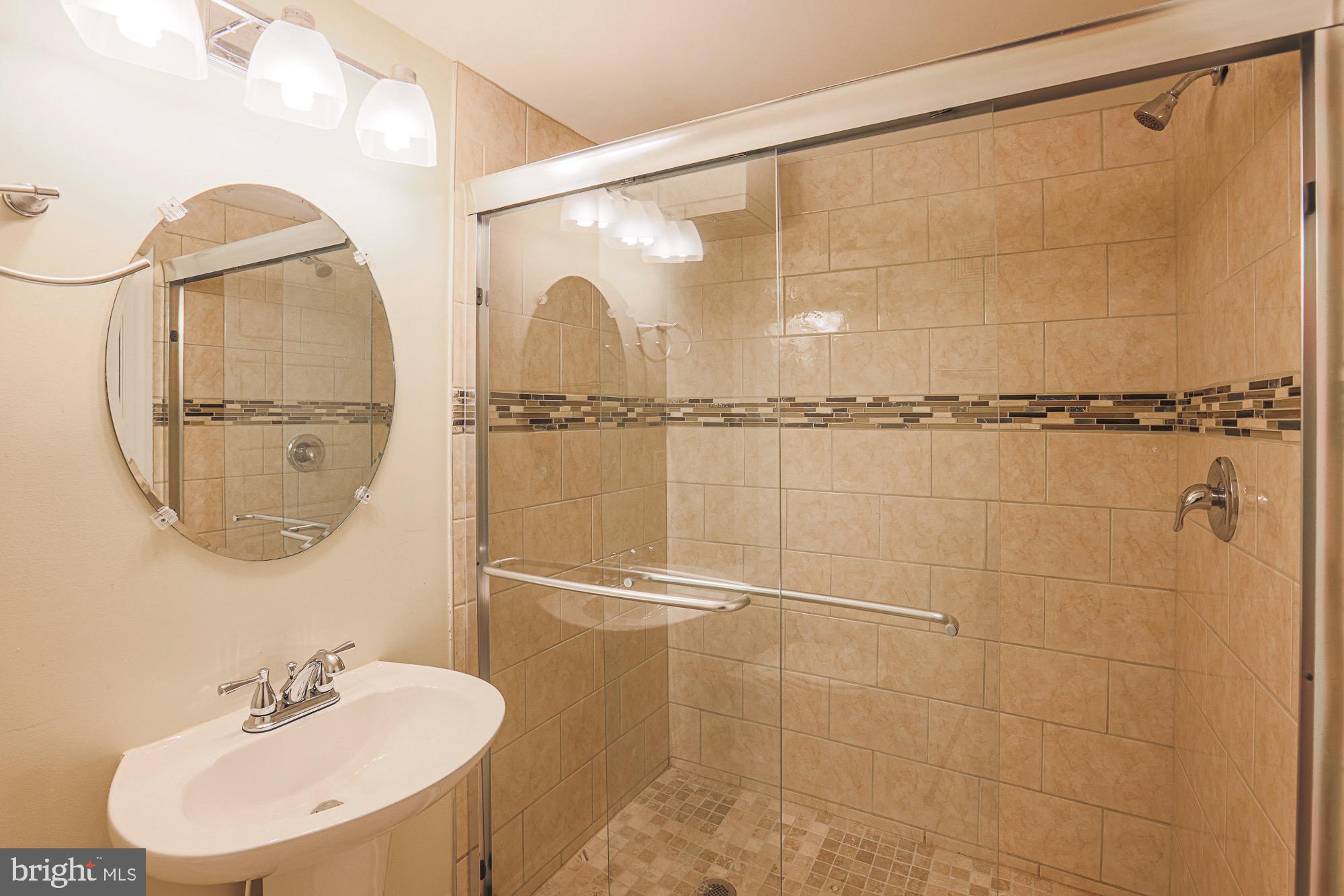 122 South Potomac Street Baltimore, MD 21224 - Photo 30 of 31 a bathroom with a shower and a mirror