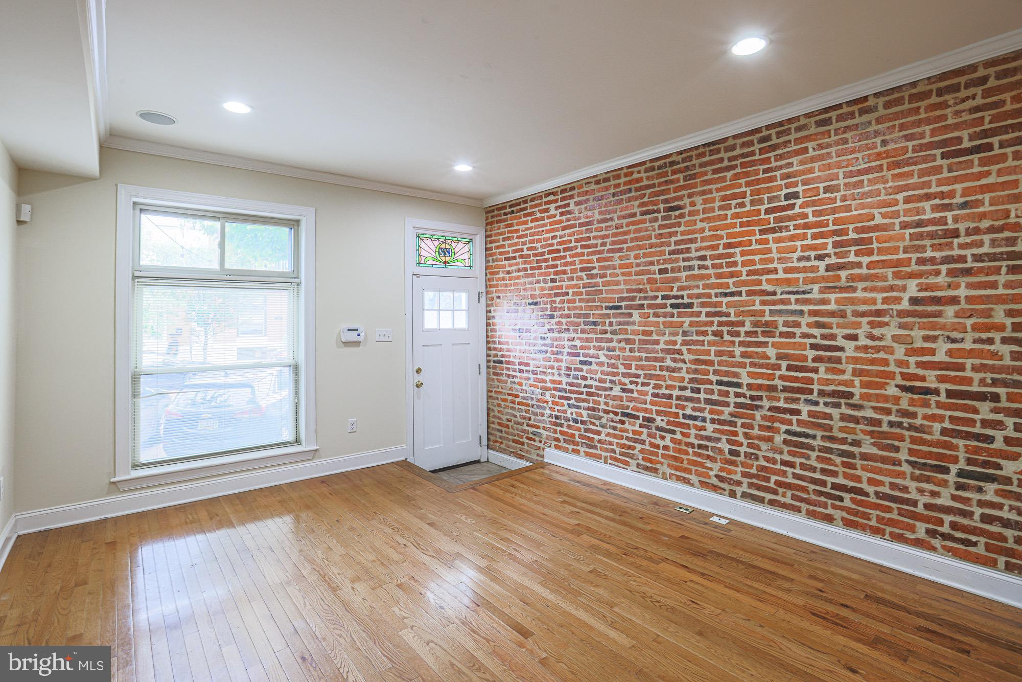 122 South Potomac Street Baltimore, MD 21224 - Photo 7 of 31 a view of an empty room with wooden floor and a window