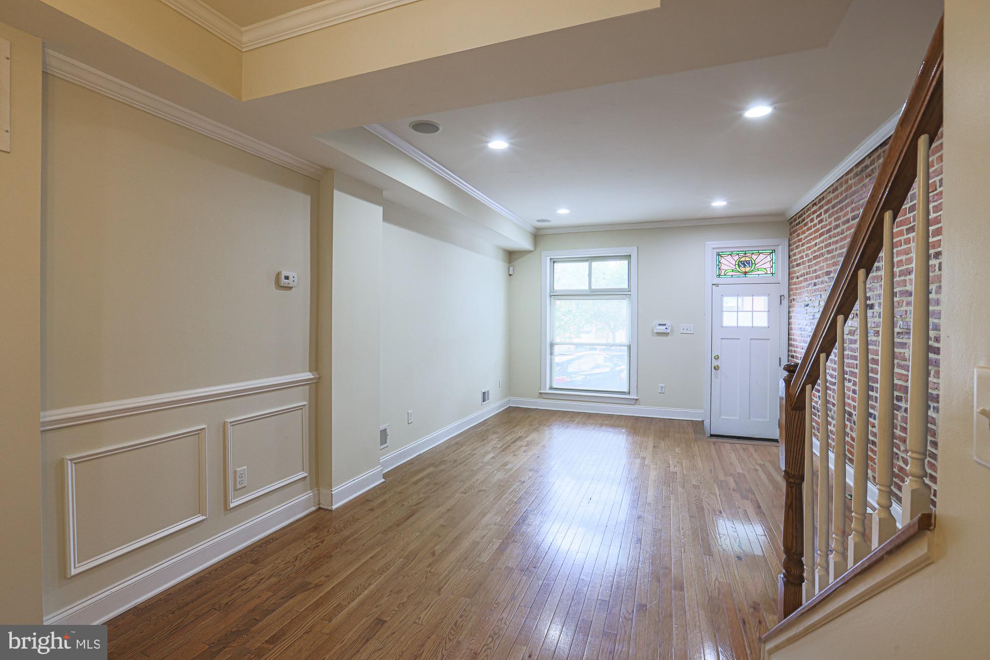 122 South Potomac Street Baltimore, MD 21224 - Photo 9 of 31 wooden floor in an empty room with a window