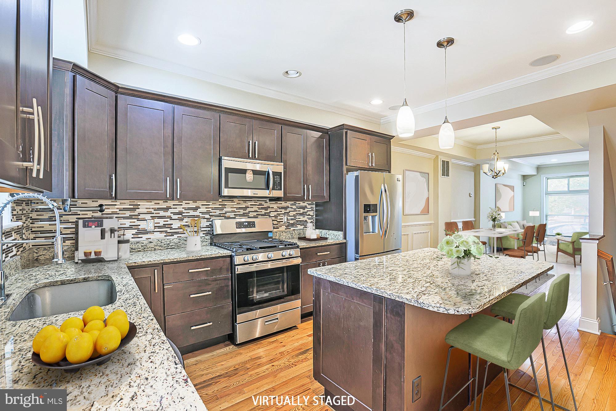 122 South Potomac Street Baltimore, MD 21224 - Photo 10 of 31 a kitchen with kitchen island granite countertop wooden cabinets and stainless steel appliances