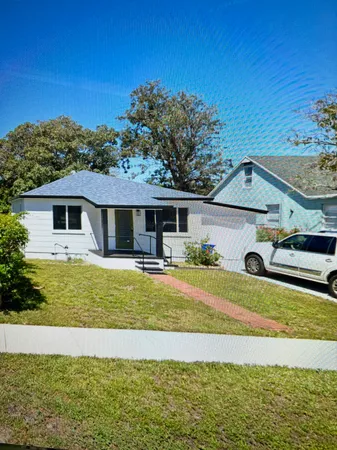 a view of a house with backyard patio and swimming pool