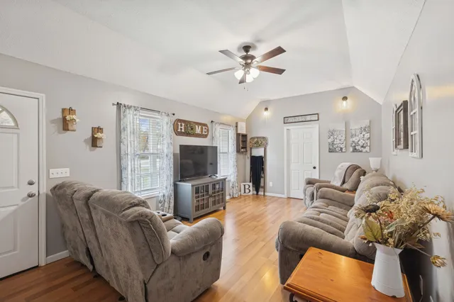 a living room with furniture and a flat screen tv