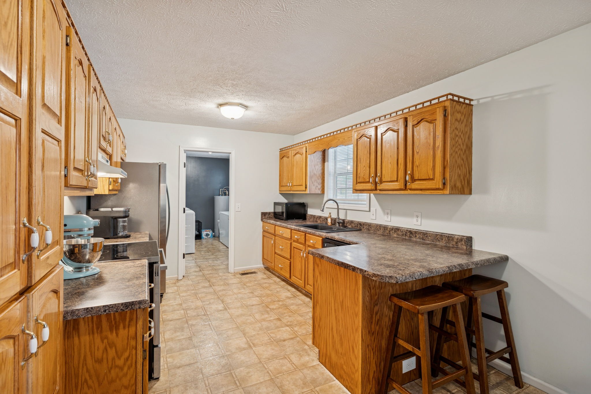 1904 Buffalo Road Hohenwald, TN 38462 - Photo 24 of 51 a kitchen with granite countertop a sink stove and cabinets