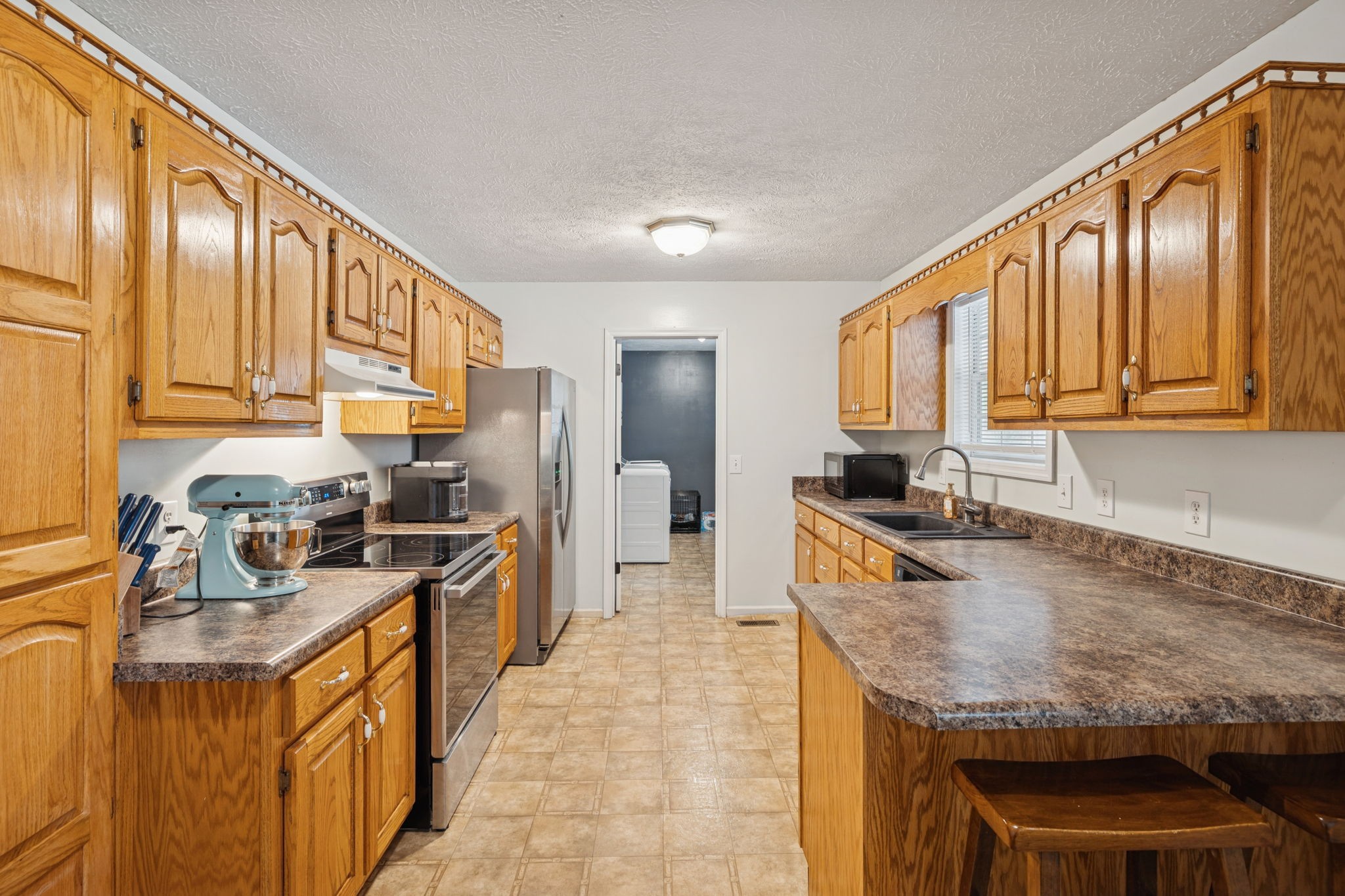 1904 Buffalo Road Hohenwald, TN 38462 - Photo 25 of 51 a large kitchen with granite countertop kitchen island stainless steel appliances a stove a sink a refrigerator and cabinets