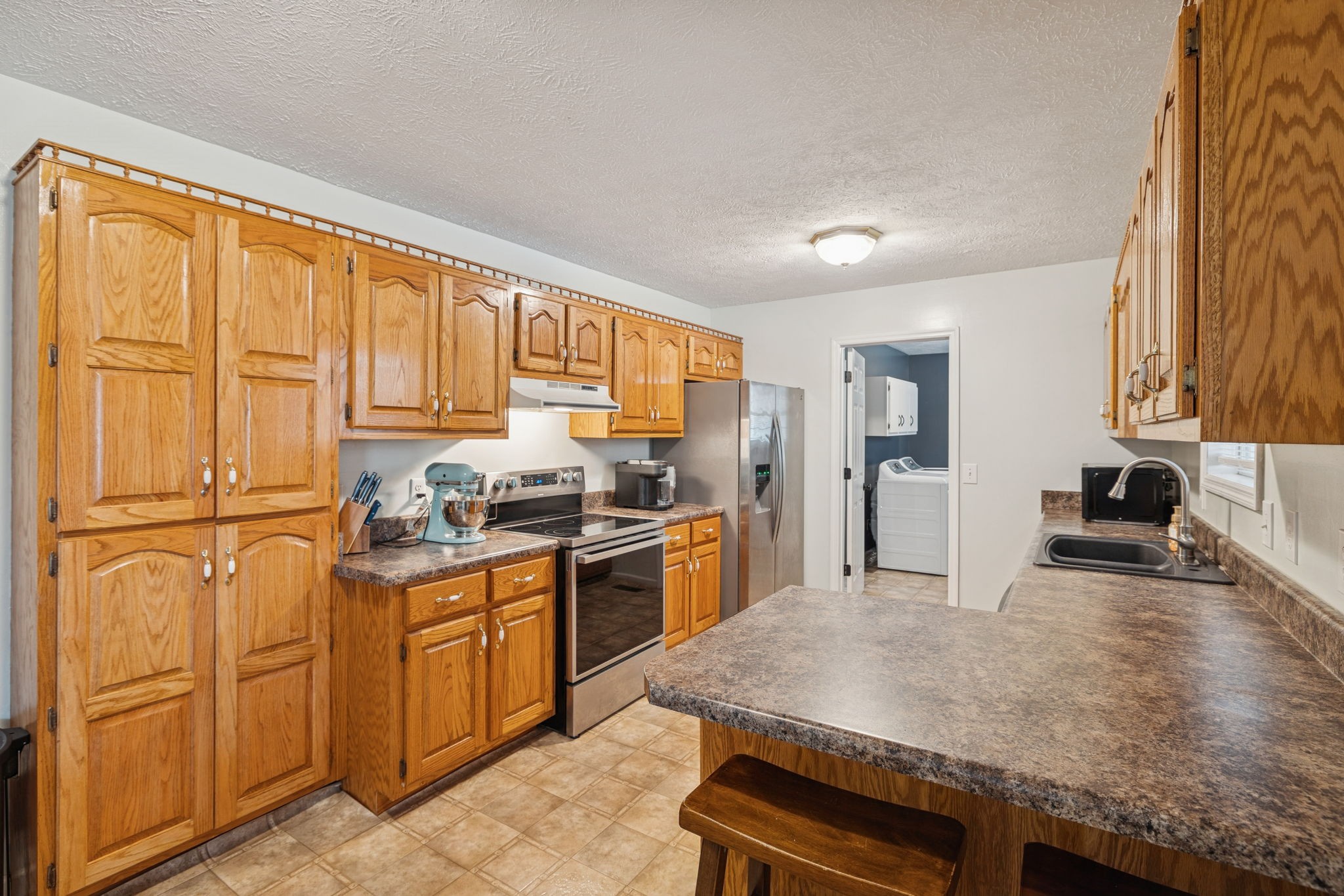 1904 Buffalo Road Hohenwald, TN 38462 - Photo 26 of 51 a kitchen with granite countertop cabinets stainless steel appliances and a sink