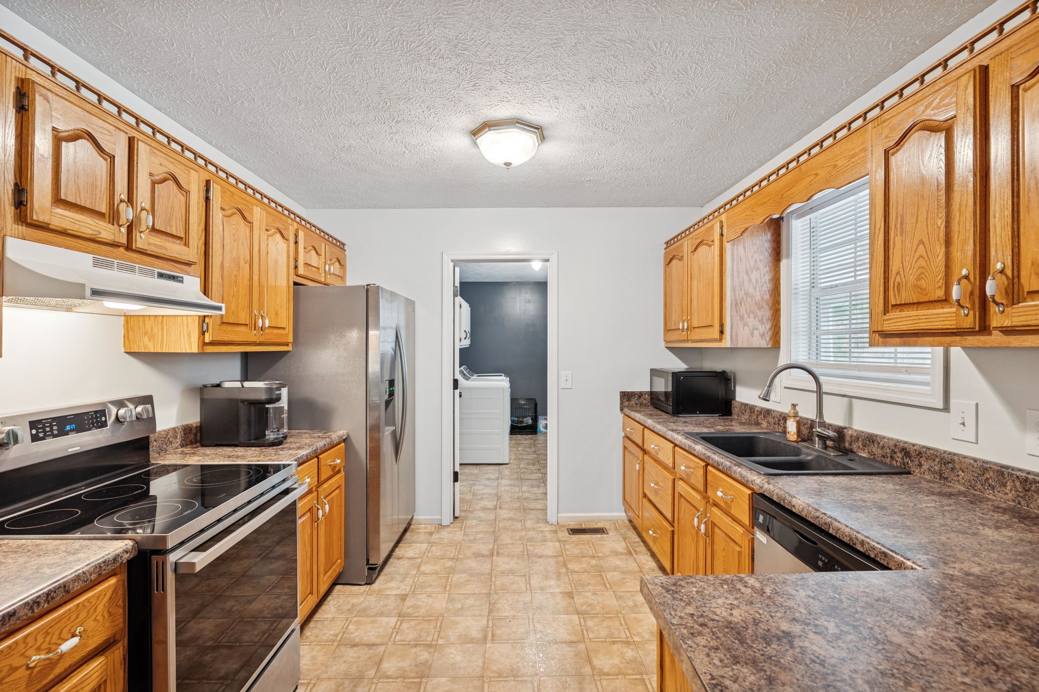 1904 Buffalo Road Hohenwald, TN 38462 - Photo 27 of 51 a kitchen with granite countertop a sink a stove and refrigerator