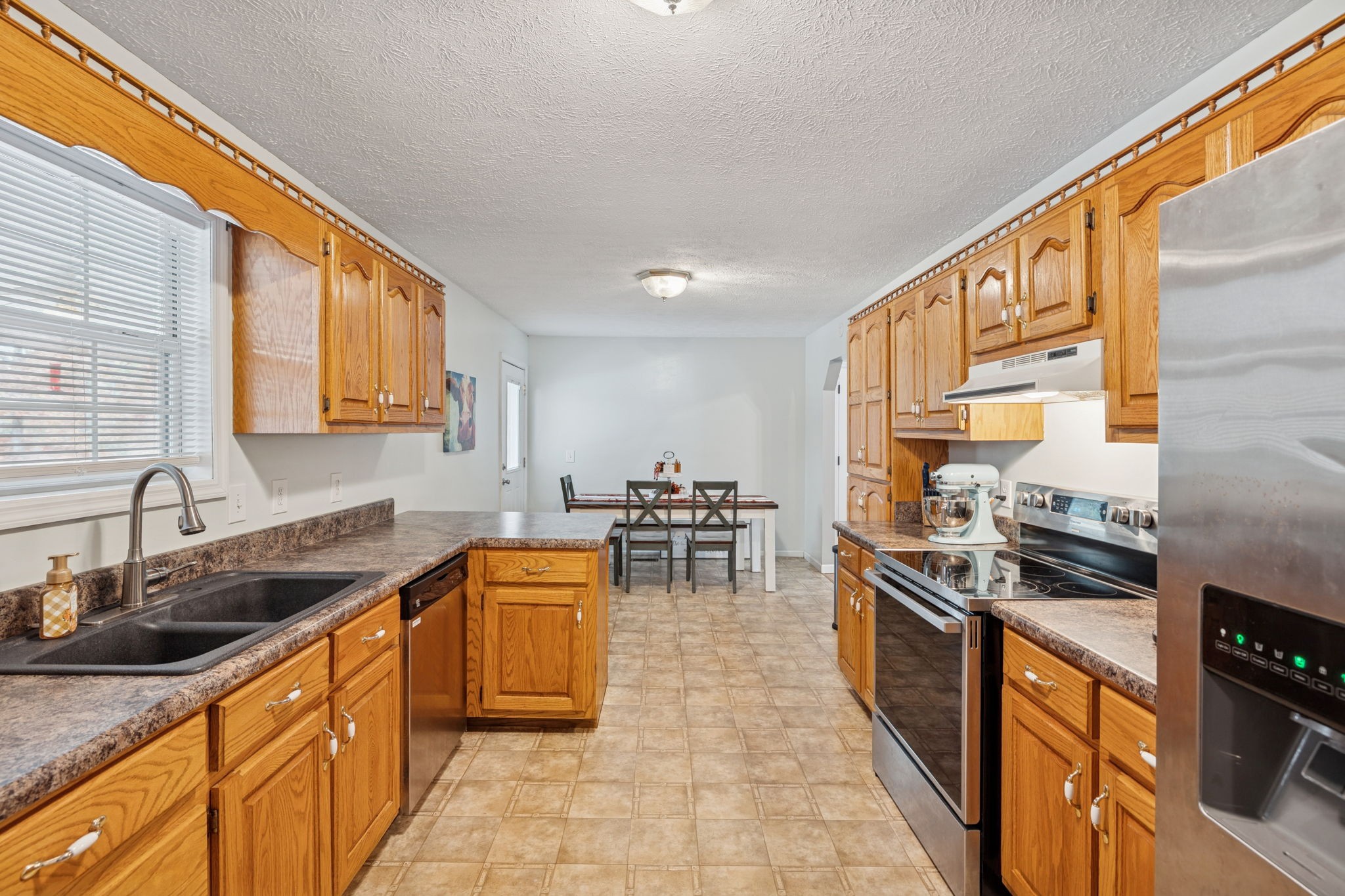 1904 Buffalo Road Hohenwald, TN 38462 - Photo 29 of 51 a kitchen with stainless steel appliances granite countertop sink stove and cabinets