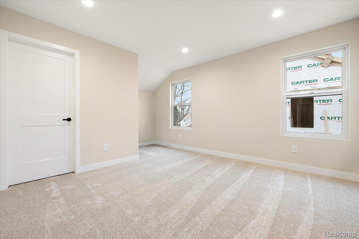 2044 Breckenridge Court Rochester, MI 48309 - Photo 28 of 33 Spare room with light carpet, vaulted ceiling, and recessed lighting