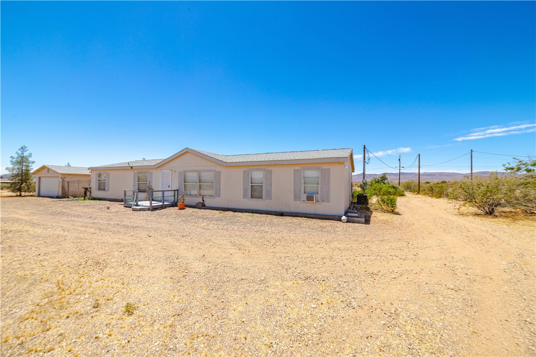 4729 Stewart Mountain Road Golden Valley, AZ 86413 - Photo 2 of 28 a house view with a outdoor space