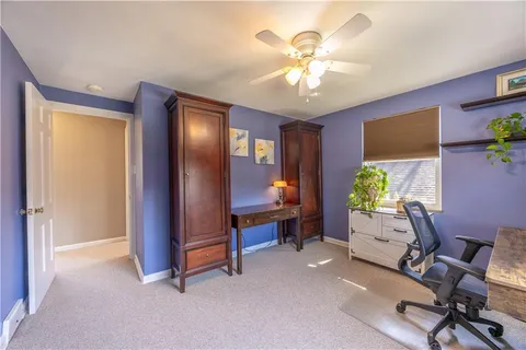 a view of a livingroom with workspace and a window