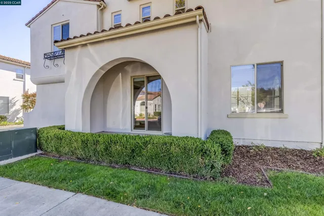 a view of a house with a swimming pool and sitting area
