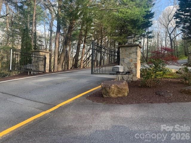 Lot 92 Mountain Summit Road, Unit 92 Zirconia, NC 28790 - Photo 6 of 9 a wooden bench sitting in middle of a yard
