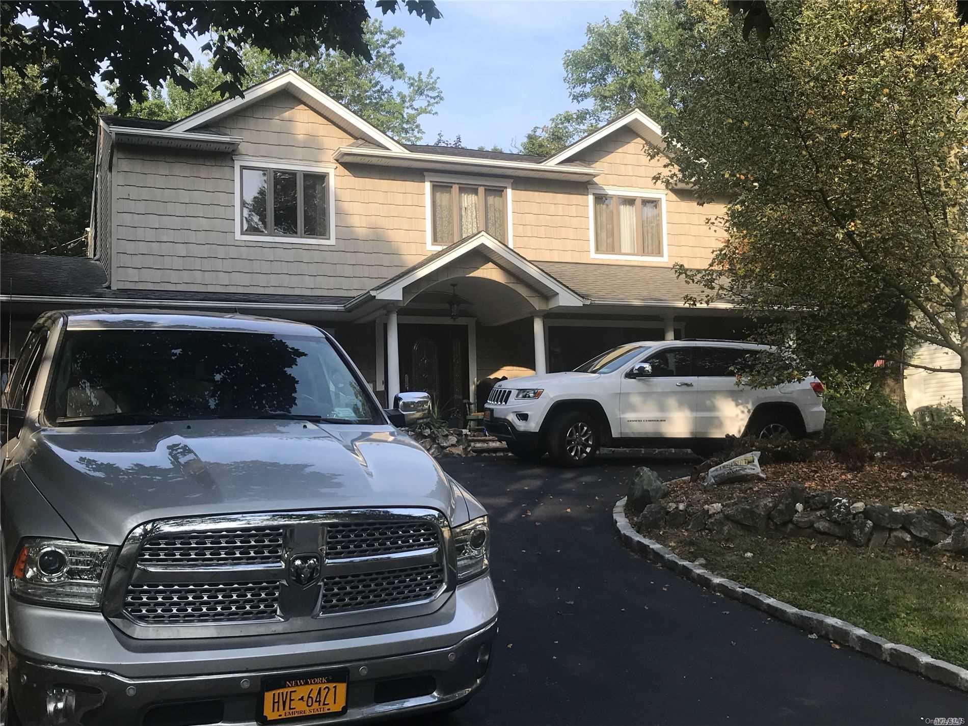 22 Sandra Drive Smithtown, NY 11788 - Photo 1 of 1 a front view of a house with a parking space