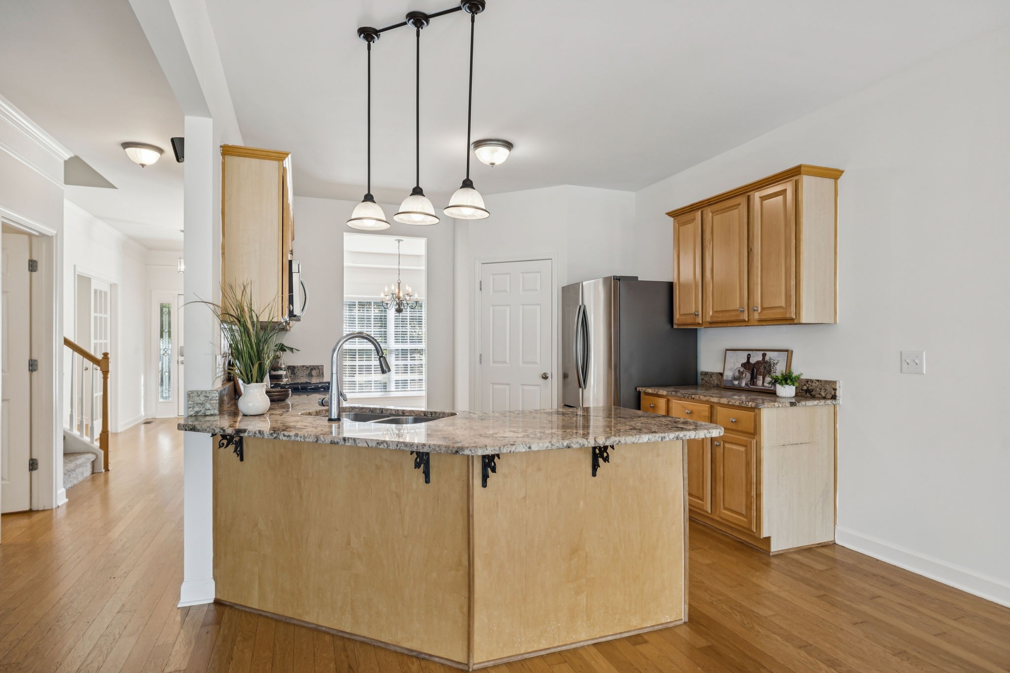 2006 Flocking Drive Spring Hill, TN 37174 - Photo 22 of 86 a kitchen with stainless steel appliances a refrigerator a sink dishwasher a stove and white cabinets with wooden floor