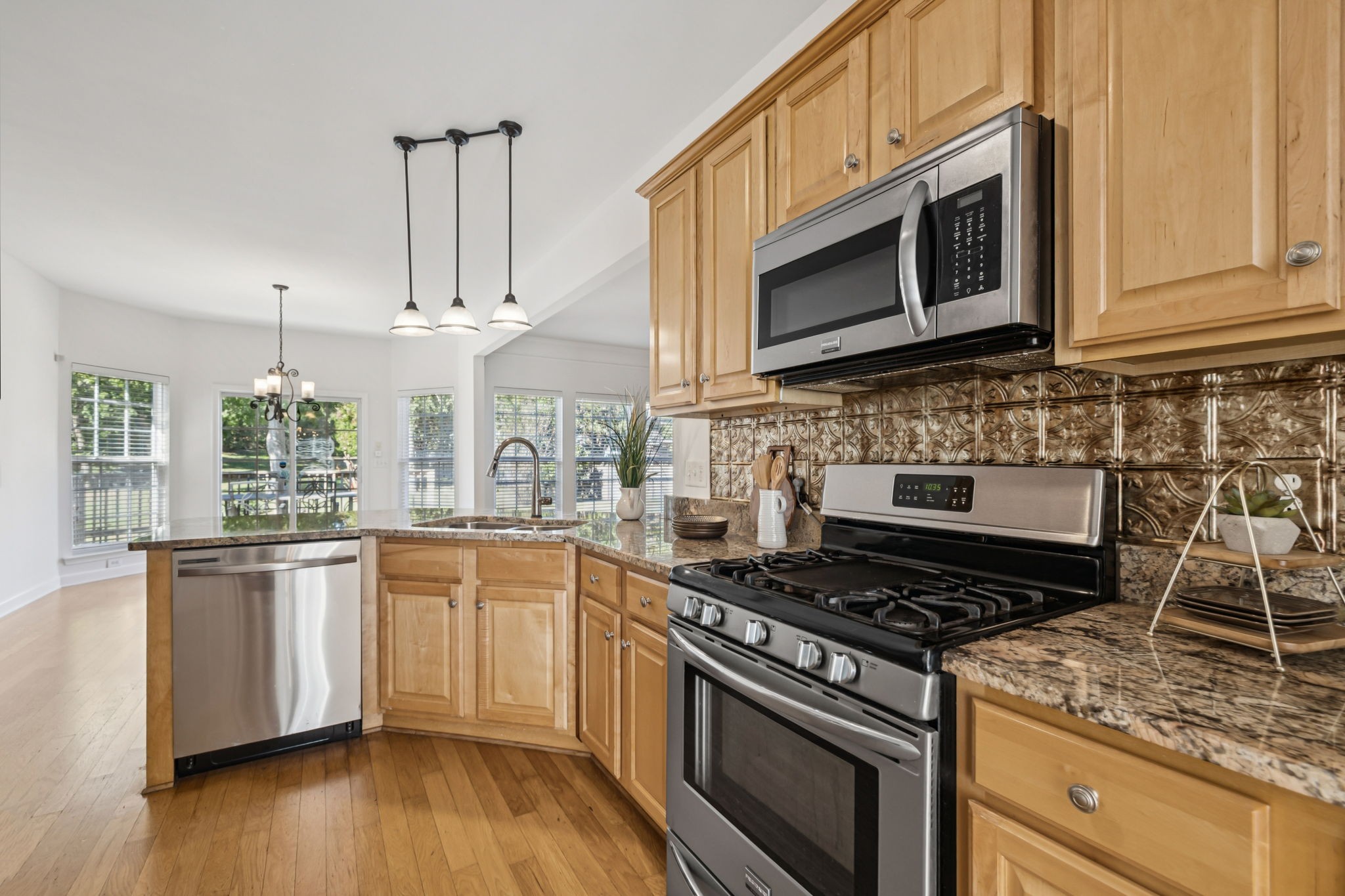 2006 Flocking Drive Spring Hill, TN 37174 - Photo 25 of 86 a kitchen with stainless steel appliances granite countertop a stove a sink and a microwave