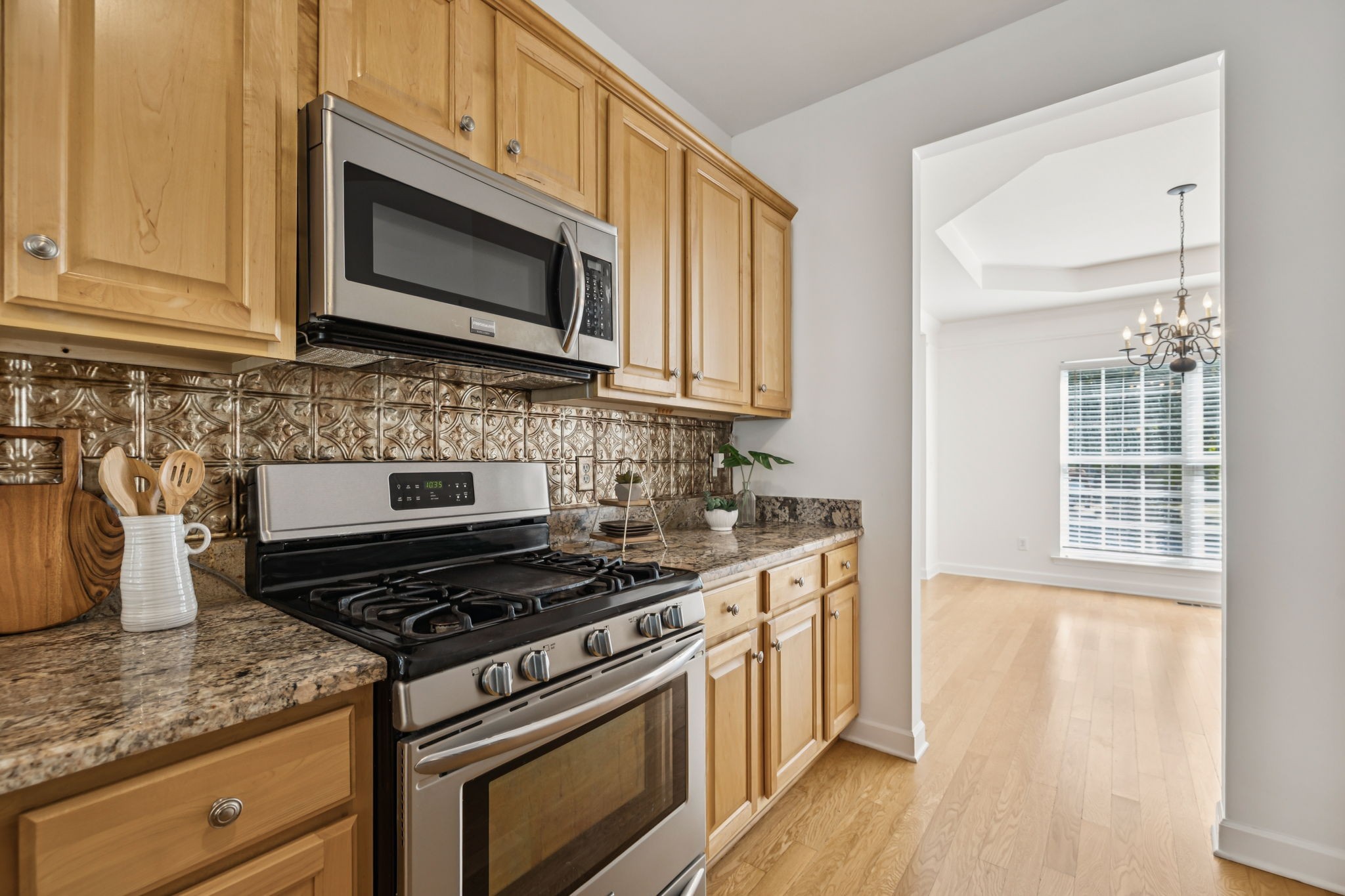 2006 Flocking Drive Spring Hill, TN 37174 - Photo 26 of 86 a kitchen with stainless steel appliances granite countertop a stove and a microwave
