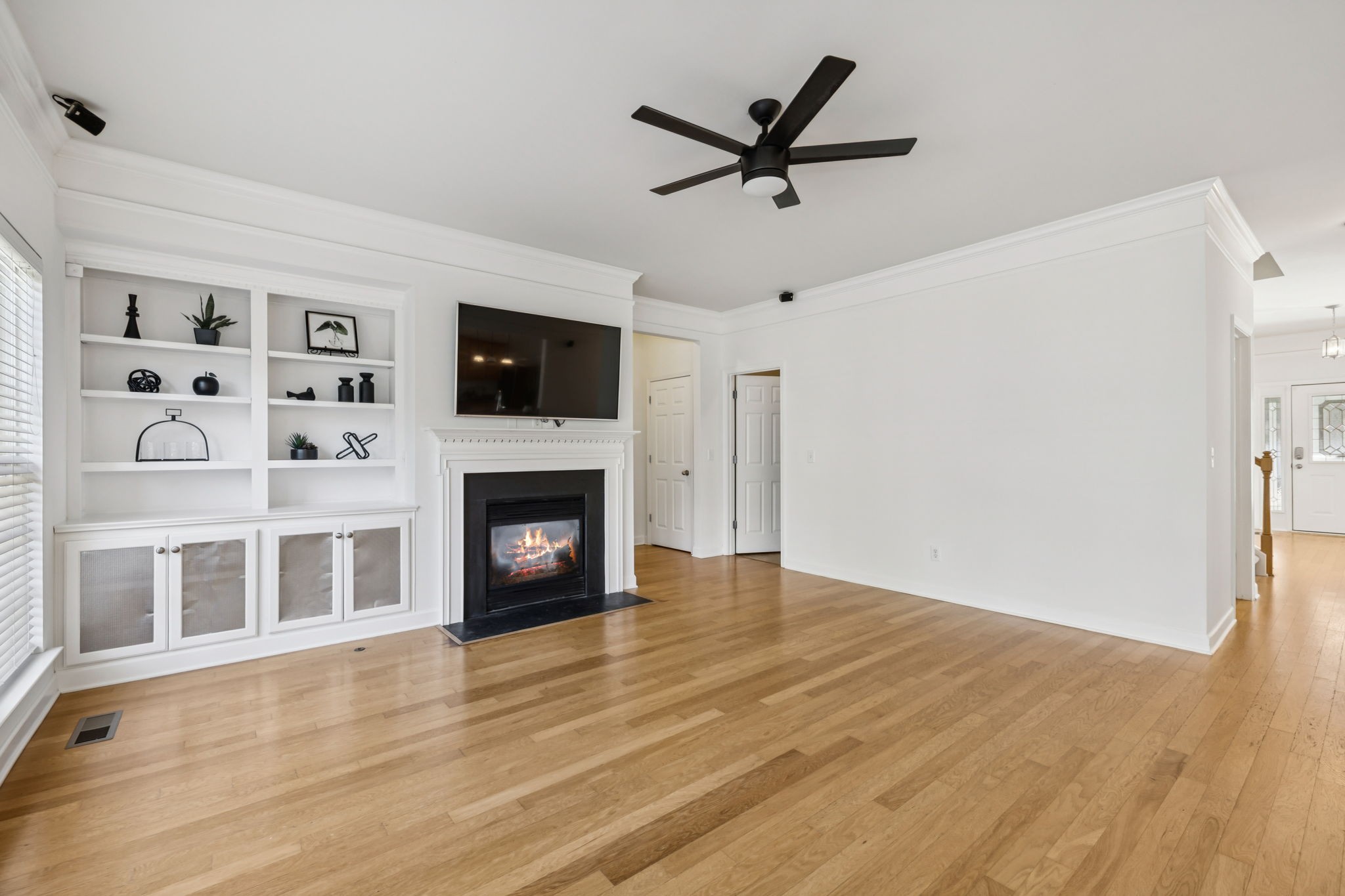 2006 Flocking Drive Spring Hill, TN 37174 - Photo 10 of 86 a view of a livingroom with a fireplace a ceiling fan and wooden floor